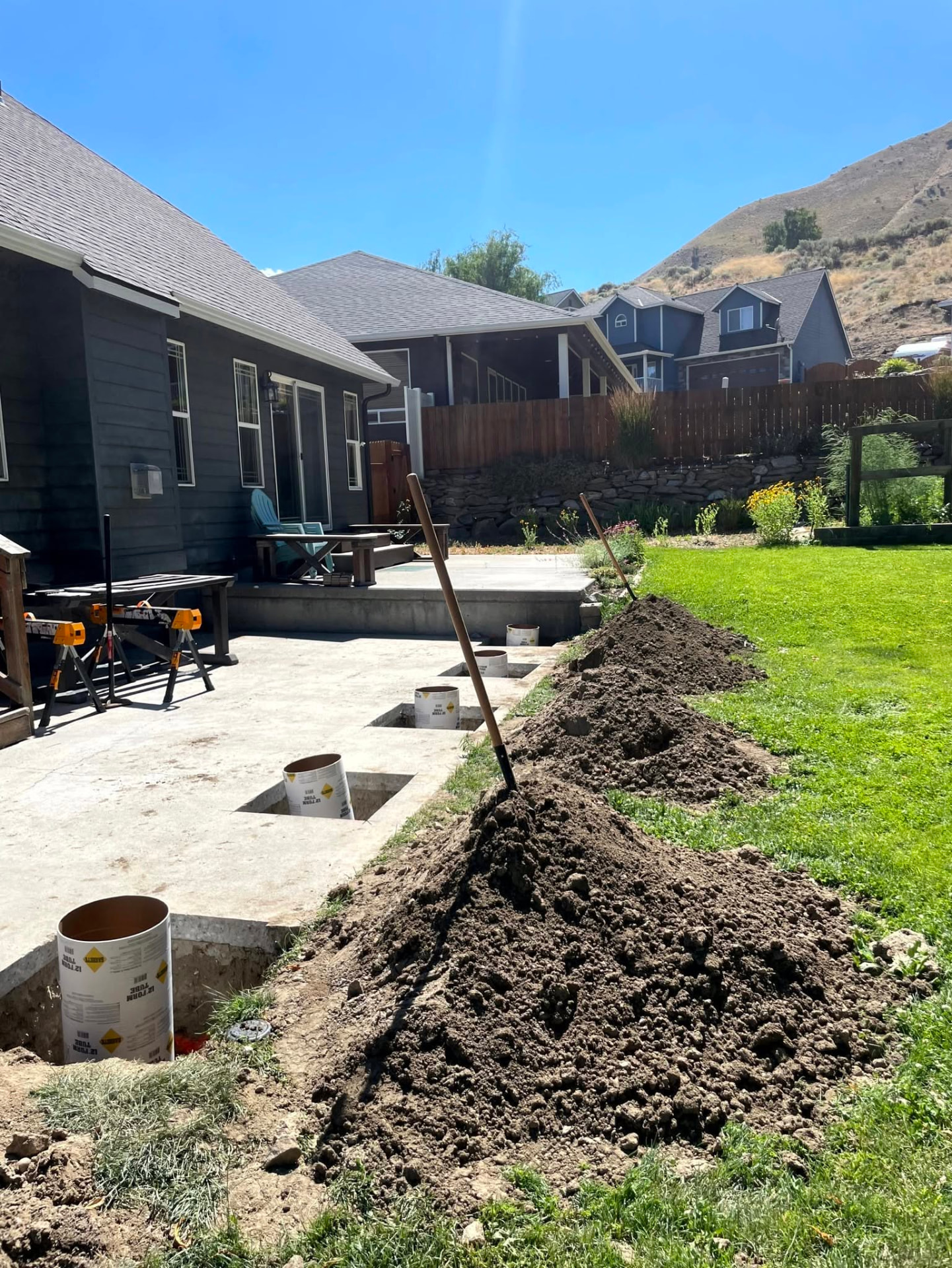 Deck footings and post bases laid out during site prep